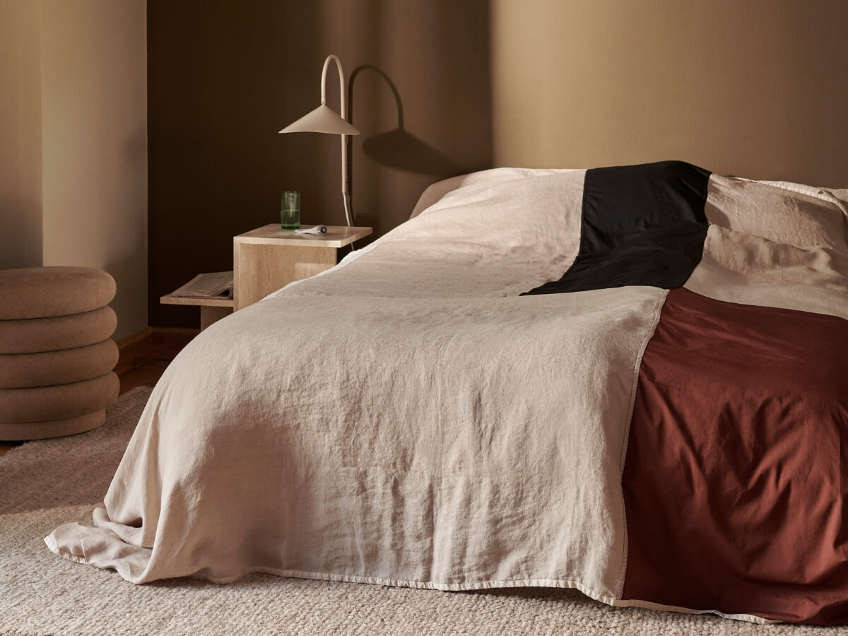 Vrchná prikrývka postele v minimalistickej spálni.