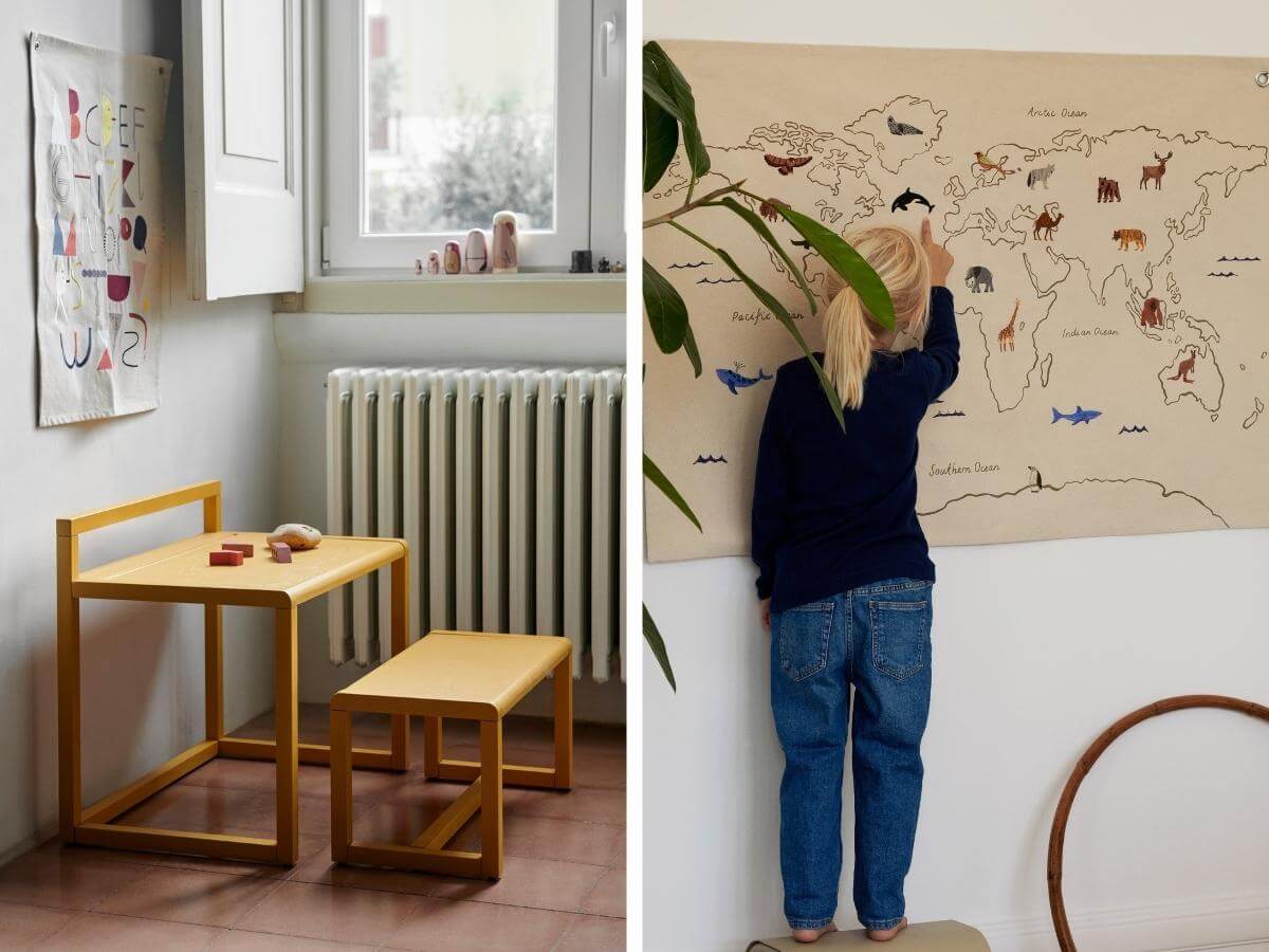 Minimalistický detský stolík so stoličkou a dieťa pozerajúce si detskú mapu sveta.