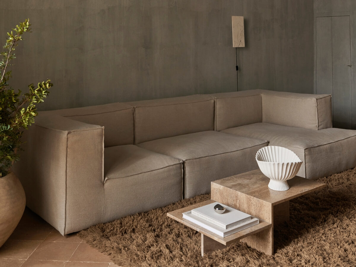 Béžová sedačka v modernej minimalistickej obývačke.