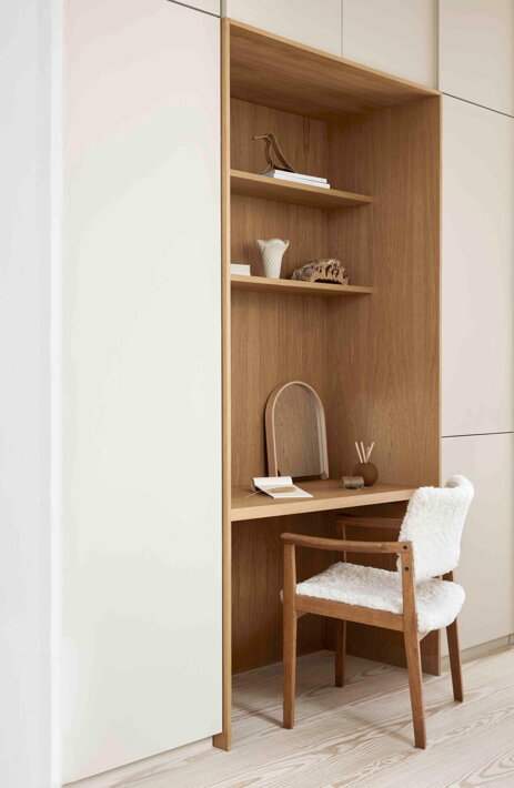 Dizajnové zrkadlo s dreveným rámom na kozmetickom stolíku v spálni