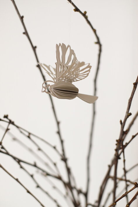 Závesný dekoratívny vtáčik z papiera v pieskovej farbe na vetvičke