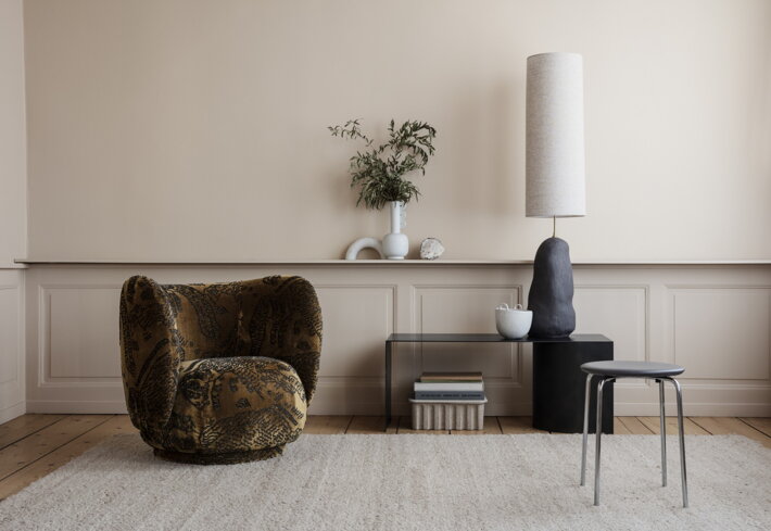 Nepravidelný dizajnový kvetináč z bielej kameniny na stole v minimalistickej obývačke
