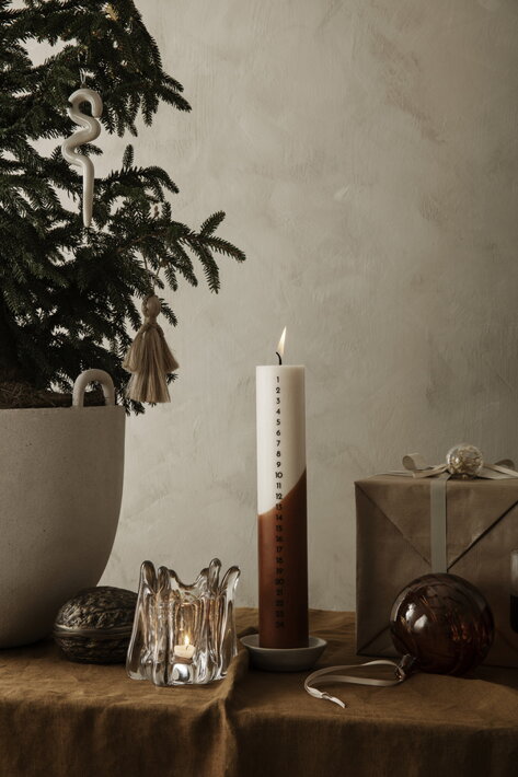Dizajnový sklenený svietnik na čajovú sviečku na stole s adventnou sviečou a vianočným stromčekom v kvetináči