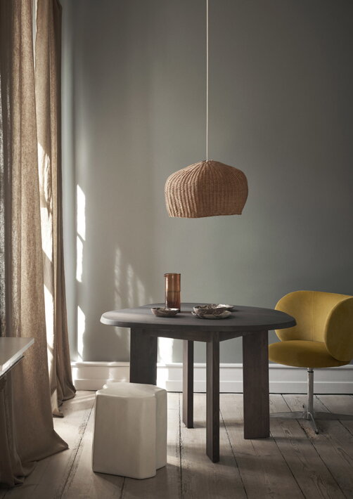 Otočná žltá stolička pri stolíku s dizajnovými miskami