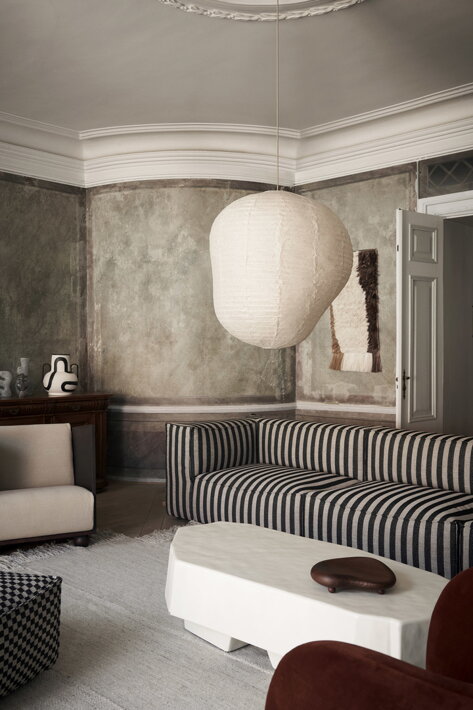 Dizajnový podnos z jaseňového dreva tmavohnedej farby na svetlom stolíku v obývačke