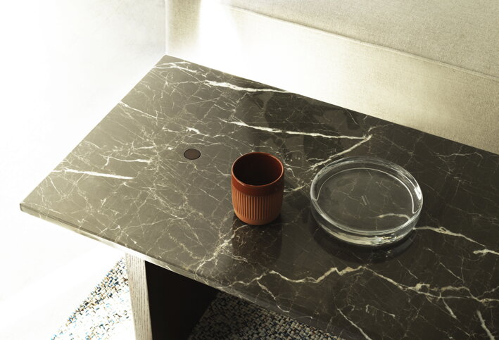 Okrúhly sklenený podnos na mramorovom stole v obývačke