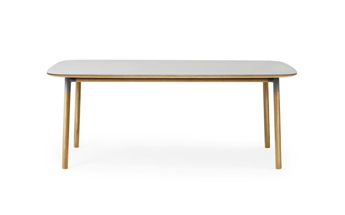Obdĺžnikový jedálenský stôl so sivou stolovou doskou z linolea a masívnymi dubovými nohami