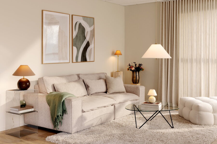 Hnedá stolová lampa Iris v obývačke na príručnom stolíku vedľa béžovej pohovky.