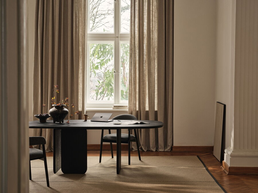 Čierny jedálenský stôl v jedálni so stoličkami.